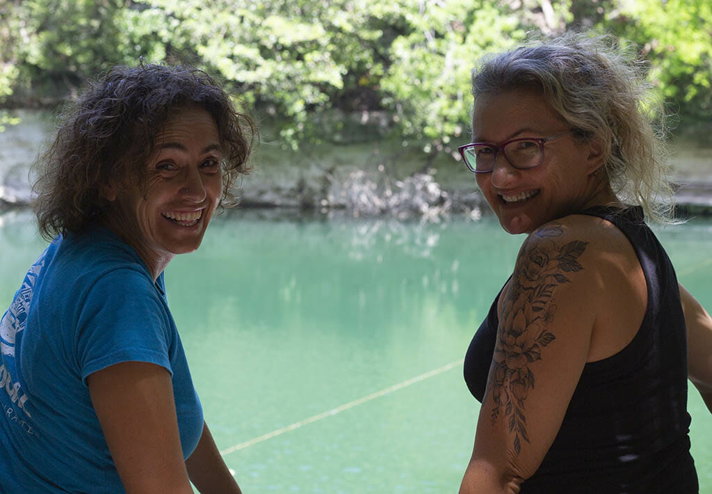 two girls in front of a cenote
